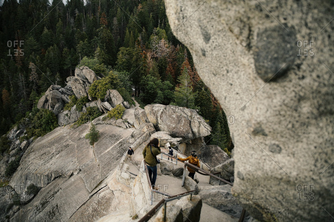 People climbing steps on the side of a mountain