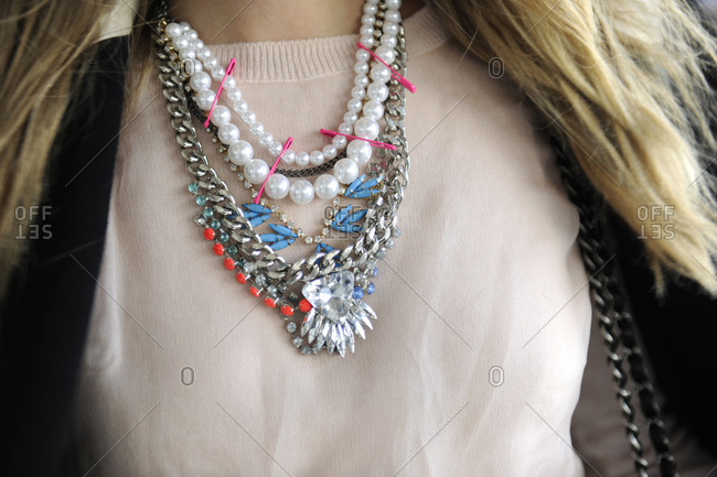 A woman wears a mix of necklaces