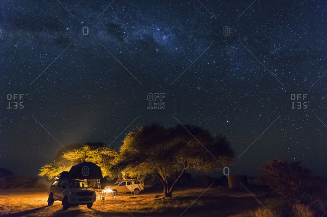 Campsite with campfire under starry sky, Central Kalahari Game Reserve, Kalahari, Botswana