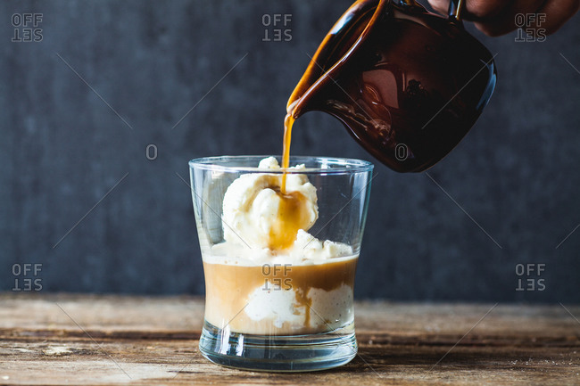 Vanilla ice cream being topped with hot espresso to make affogato dessert