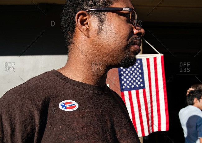 Man with voting sticker outside voting place