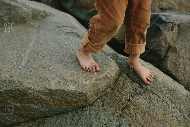 Feet of a boy on rocks