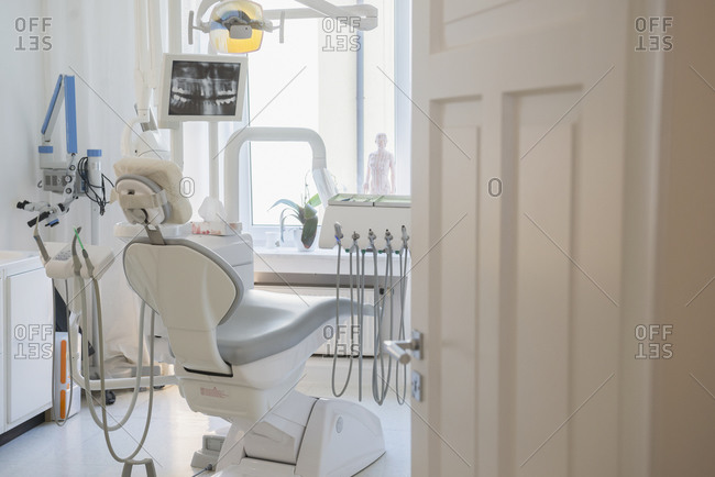 Dental chair and equipment in an empty exam room