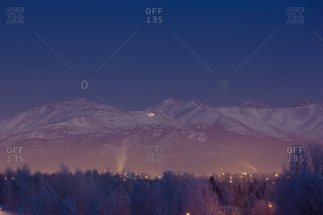 View Of The Chugach Mountains At Twilight With The Site Summit Star Visible Atop Mount Gordon Lyon During Winter, Anchorage, South-central Alaska