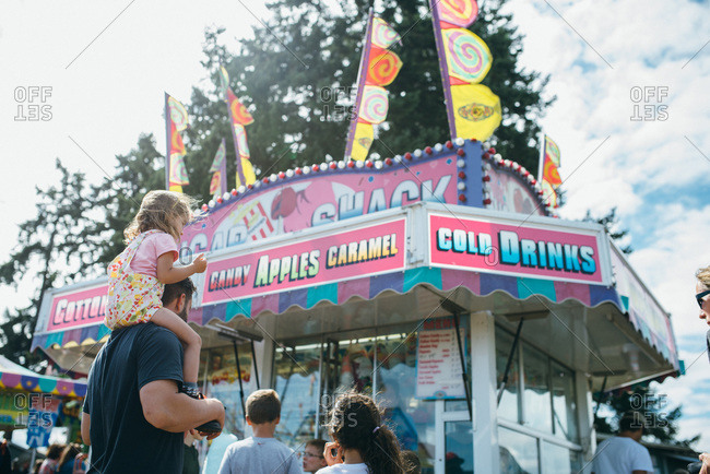 Father and daughter at a carnival food stand