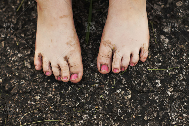 Closeup of a child\'s dirty feet and pink toenails