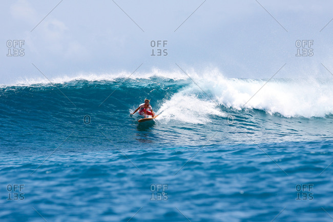 Surfing woman, South Male Atoll, Maldives