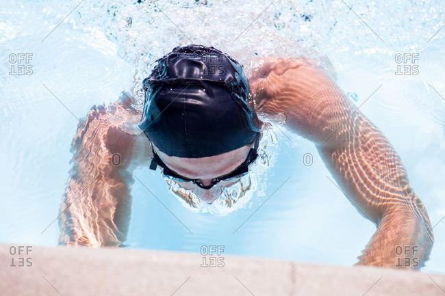 A swimmer reaches the end of his lane
