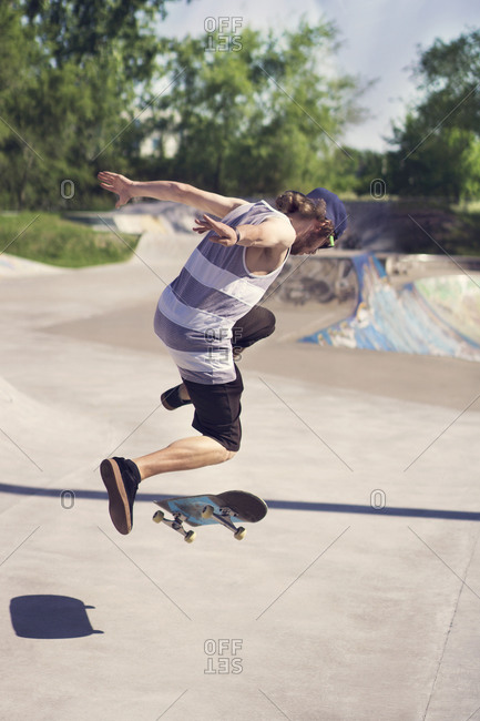 Young male skater doing jump trick