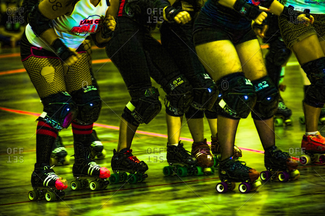 Colorful legs of roller derby female skaters