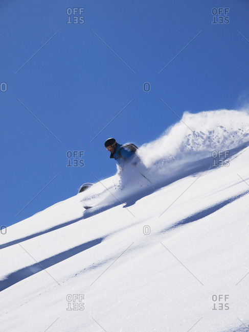 Off piste skier skiing powder, Zinal, Switzerland