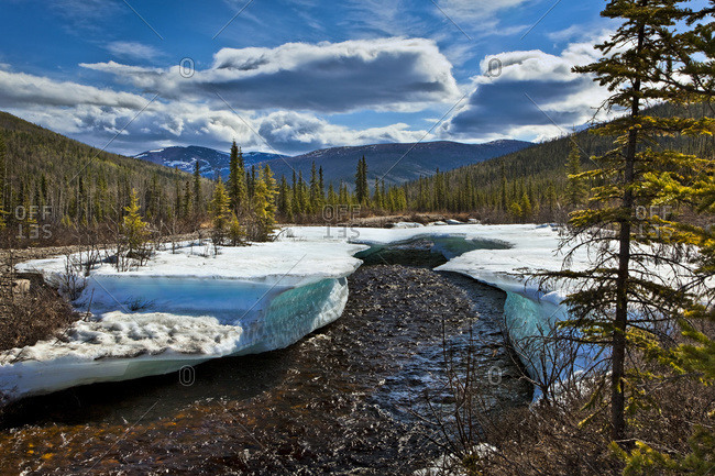 Monument Creek meanders through melting snow in early spring, Chena River State Recreation Area, Fairbanks, Alaska, United States of America
