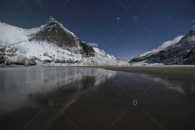 Night winter mountain reflection on Bunes beach, Moskenesoy, Lofoten Islands, Norway