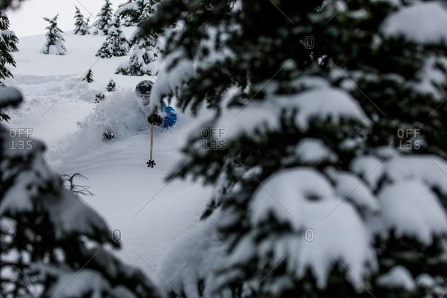 A skier barrels through deep snow
