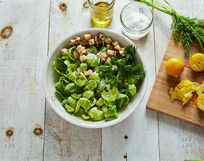 Overhead view of Brussels sprout leaf salad with lemon and croutons