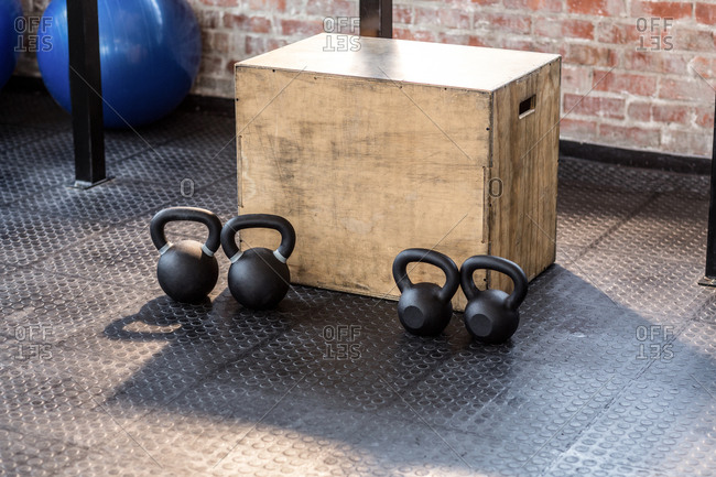Image of four kettlebells and a box