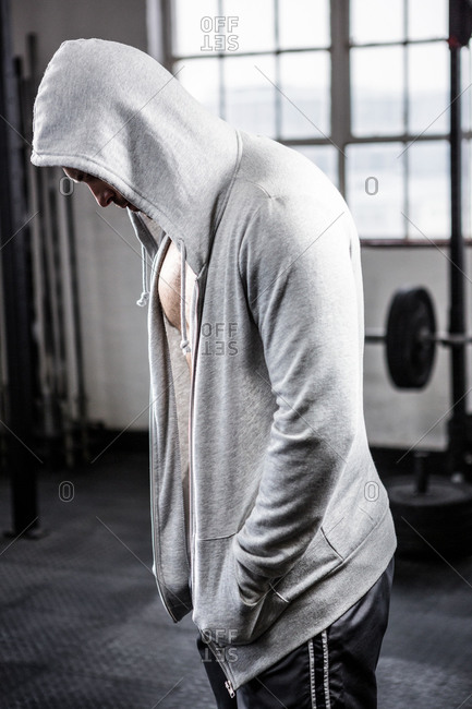 Fit man with hooded sweater at the gym