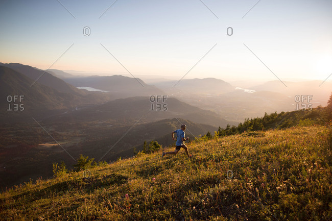 Man jogging up hill in remote mountain setting