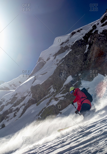 Man skiing on a steep rocky mountain