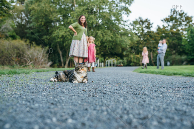 Family outdoors with their pet cat