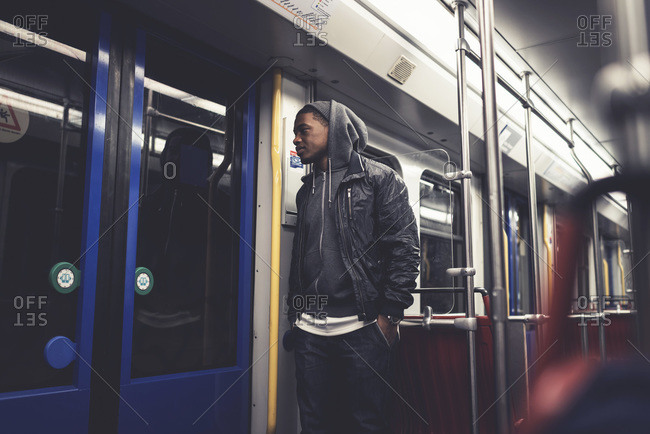 Young man waiting for the doors of a subway car to open