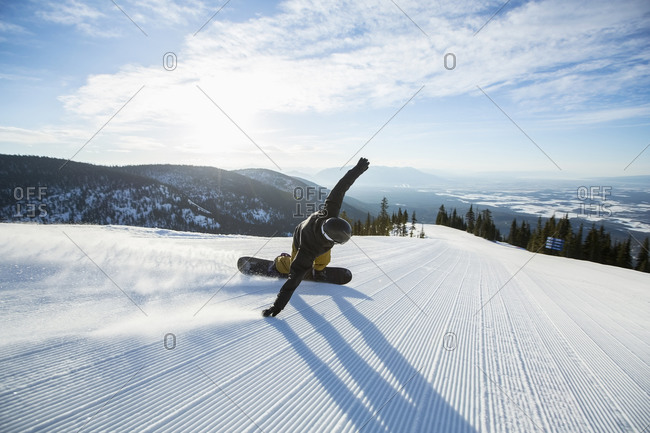 Man snowboarding down a fresh snow