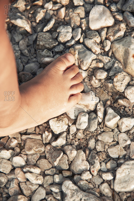 Child foot on rocks