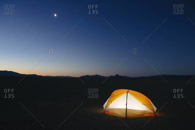 Illuminated camping tent at night in Black Rock Desert, Nevada