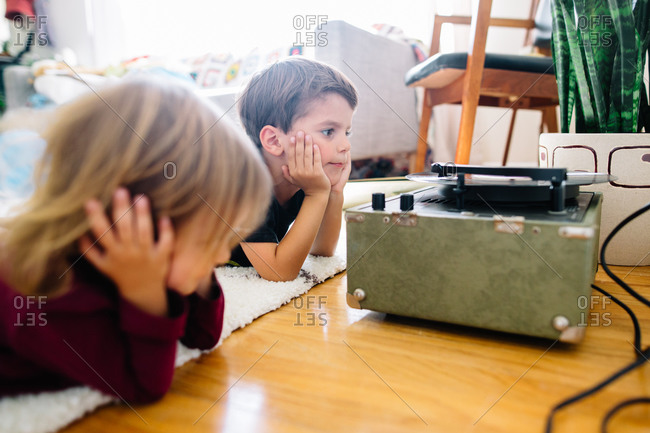 Children listen to records on the floor