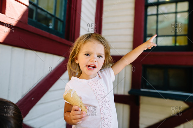 A little girl with an empty ice cream cone demands more