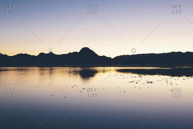 Calm waters and mountains at Bonneville Salt Flats, Utah