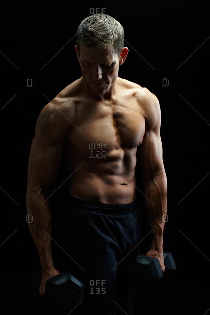Studio shot of a man with hand weights