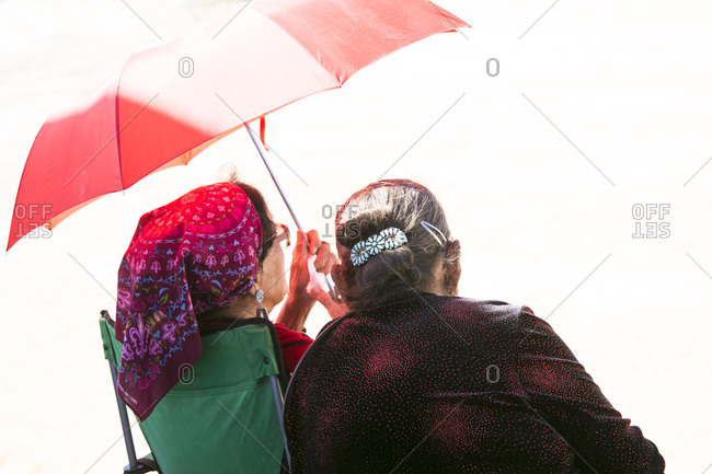 Navajo Elders under umbrella, Navajo Nation Fair, Navajo Nation, Window Rock, AZ, USA