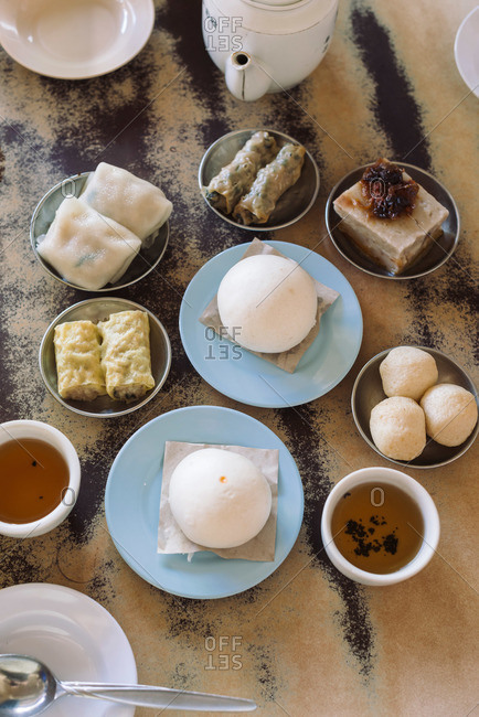 Overhead view of a table of foods for dim sum at Malaysian restaurant