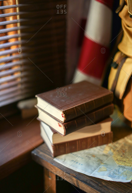 Leather bound books with hiking items on a table