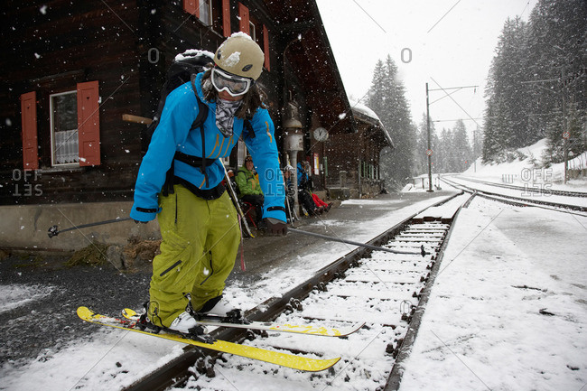 Skier at train station, Cavaduerli, Klosters, Canton of Grisons, Switzerland