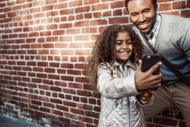 Girl taking a selfie with her dad
