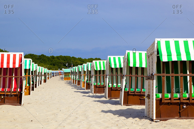 Two rows of hooded beach chairs at beach