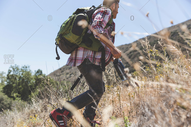 Young adult male hiking low angle view