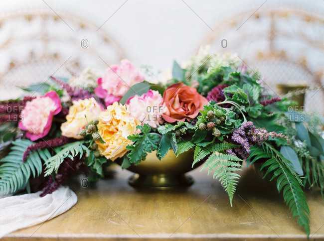 Flower arrangement in gold dish