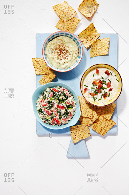 Bowls of veggie dip, ranch dip, and guacamole