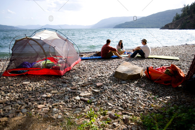 Friends camping along shore of Lake Pend Oreille, Idaho