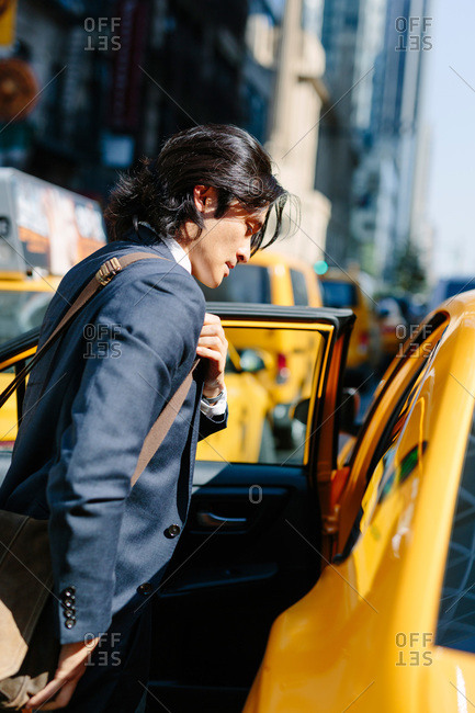 Businessman entering a taxi, New York City