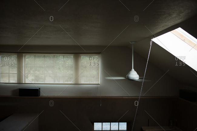 Elevated view of cement ceiling and fan of building interior