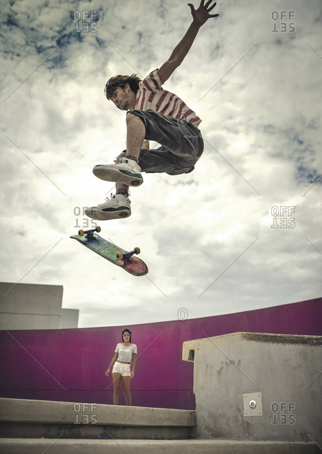 Young man doing mid-air trick on a skateboard