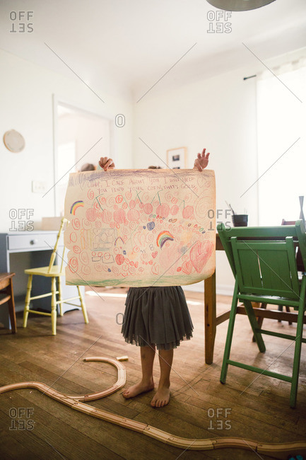 A Young girl with a picture that she drew