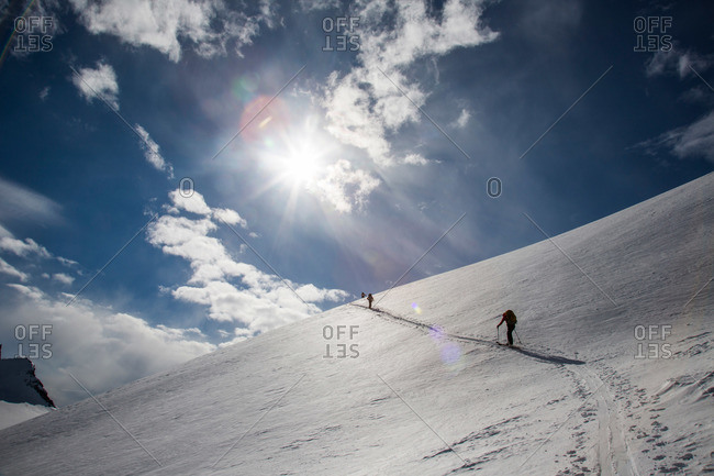Skiers ascend a steep skin track during the Spearhead Traverse in the Coast Mountains of British Columbia, Canada