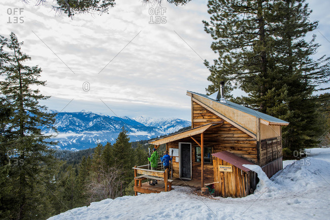 Two cross country skiers on the Mazama backcountry stop at one of the Rendezvous Huts in Washington\'s Methow Valley.