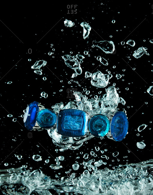 Sapphire jewelry splashing through water