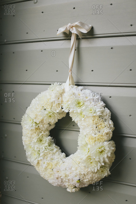 Floral wedding wreath hung with ribbon